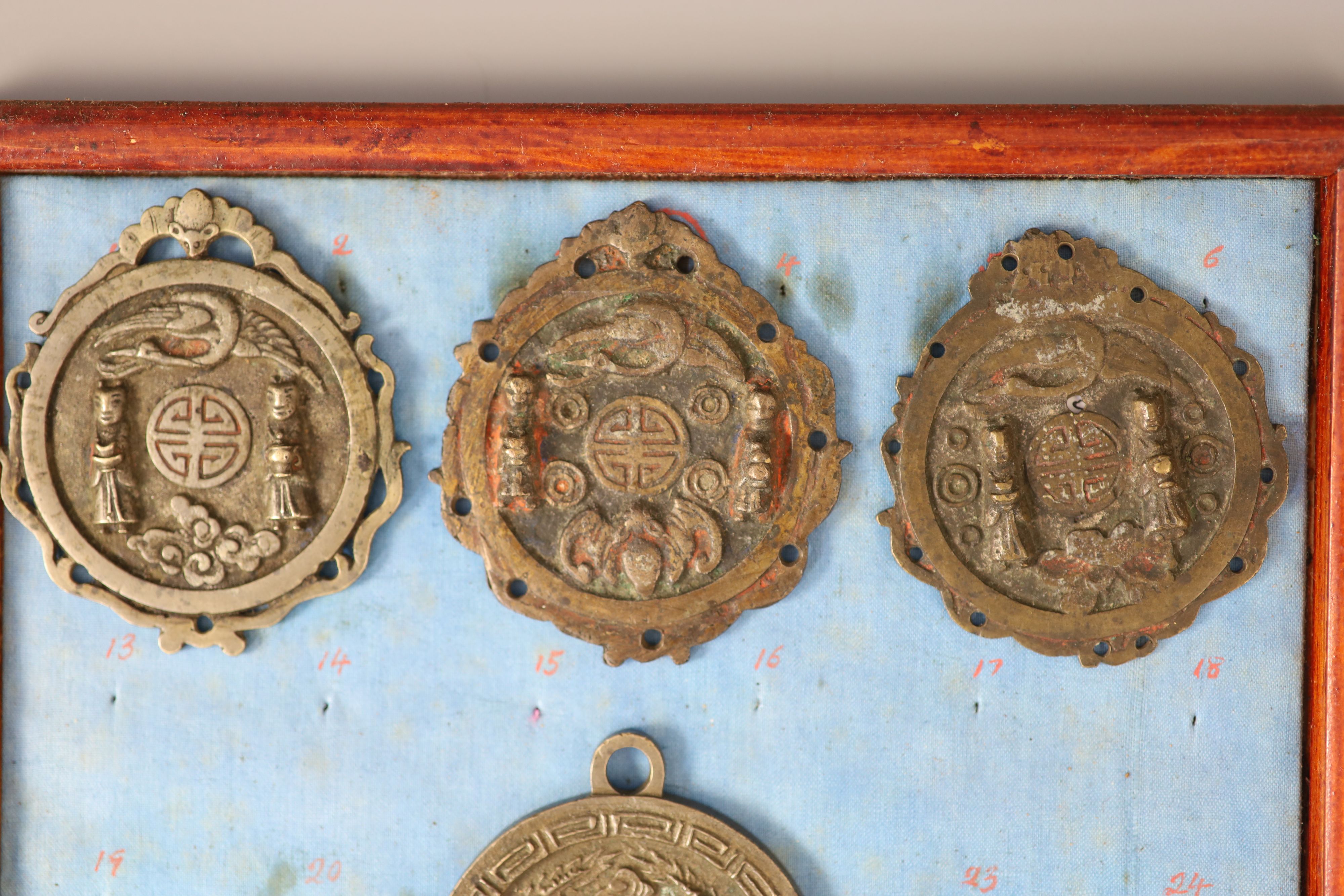 A group of 99 Korean bronze and metal amulets or charms, 19th/20th century